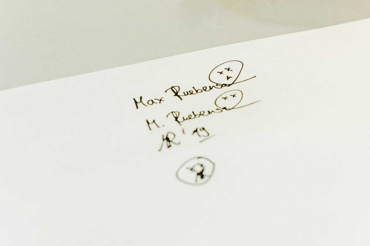 Auf einem Blatt Papier sind verschiedene Versionen einer Künstler-Signatur zu sehen